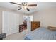 Bedroom with ceiling fan, door to dining room, neutral walls and carpet at 202 Berkeley Woods Dr, Duluth, GA 30096