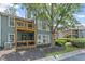 Charming two-story condo featuring wooden balconies, surrounded by vibrant greenery and a well-maintained lawn at 202 Berkeley Woods Dr, Duluth, GA 30096