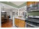 Kitchen featuring granite countertops, modern appliances, and an open layout leading to the dining room at 202 Berkeley Woods Dr, Duluth, GA 30096