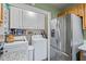 Functional kitchen includes stainless steel refrigerator, washer and dryer, and ample storage at 202 Berkeley Woods Dr, Duluth, GA 30096