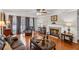 Comfortable living room featuring a fireplace, hardwood floors, and a sitting area with natural light at 202 Berkeley Woods Dr, Duluth, GA 30096