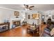 Cozy living room with hardwood floors, a fireplace, and an open view into the kitchen at 202 Berkeley Woods Dr, Duluth, GA 30096