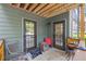 Comfortable outdoor patio with neutral walls and ceiling, featuring two doors, seating, and decor at 202 Berkeley Woods Dr, Duluth, GA 30096