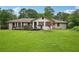 Large backyard with a deck, perfect for outdoor entertaining, and expansive grassy area at 2676 Abington Dr, Snellville, GA 30078