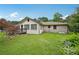 View of the backyard with a deck, brick exterior, and a spacious lawn at 2676 Abington Dr, Snellville, GA 30078