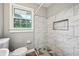 Updated bathroom showcasing a tiled shower with built-in niche and modern fixtures at 2676 Abington Dr, Snellville, GA 30078