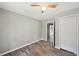 Bedroom with hardwood floors, ceiling fan, closet, and neutral paint scheme at 2676 Abington Dr, Snellville, GA 30078