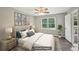 Comfortable bedroom featuring hardwood floors, ceiling fan, and ensuite bathroom at 2676 Abington Dr, Snellville, GA 30078