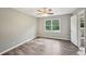 Bedroom featuring hardwood floors, a ceiling fan, and a window at 2676 Abington Dr, Snellville, GA 30078