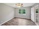 Inviting bedroom with hardwood floors, a ceiling fan, and a window overlooking the backyard at 2676 Abington Dr, Snellville, GA 30078