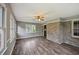 The living room has hardwood floors, neutral colored walls, large windows, and a brick accent wall at 2676 Abington Dr, Snellville, GA 30078