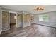 Open living room has hardwood floors, neutral colored walls, a brick accent wall and large windows at 2676 Abington Dr, Snellville, GA 30078