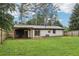 Spacious backyard with a covered patio, green grass, a brick home, and a wood fence at 3351 Landrum Se Dr, Smyrna, GA 30082