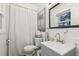 Cozy bathroom features white fixtures, a patterned mirror, modern sink, and a shower with curtain at 3351 Landrum Se Dr, Smyrna, GA 30082