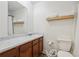 Clean bathroom features wood vanity, a sink with marble countertop, toilet, mirror, and a shower at 3351 Landrum Se Dr, Smyrna, GA 30082