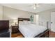 Bedroom featuring hardwood floors, a large bed, nightstands, a ceiling fan, and a window at 3351 Landrum Se Dr, Smyrna, GA 30082