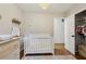 Bright Bedroom featuring a white crib, dresser, and a closet for ample storage at 3351 Landrum Se Dr, Smyrna, GA 30082