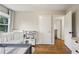 Cozy bedroom featuring hardwood floors, a white crib, a playpen, and a doorway leading to another room at 3351 Landrum Se Dr, Smyrna, GA 30082