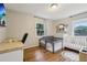 Bright bedroom with hardwood floors, a playpen, white crib, desk, and a TV with a view of the ocean at 3351 Landrum Se Dr, Smyrna, GA 30082