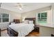 Bedroom featuring hardwood floors, a large bed, nightstands, a ceiling fan, and two windows at 3351 Landrum Se Dr, Smyrna, GA 30082