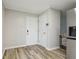 Kitchen entryway featuring white shaker doors, neutral walls, and wood-look vinyl flooring at 3351 Landrum Se Dr, Smyrna, GA 30082