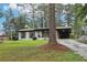 Charming single-story home featuring a covered carport and freshly landscaped yard with mature trees at 3351 Landrum Se Dr, Smyrna, GA 30082
