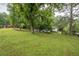 Scenic view of the property featuring a white house, barn, and a wooden fence at 7505 Rico Rd, Chattahoochee Hills, GA 30268