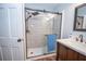 Modern bathroom featuring new shower, tiled walls, glass enclosure, and updated sink at 7505 Rico Rd, Chattahoochee Hills, GA 30268