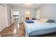 Bedroom with neutral walls and hardwood floors with view to the kitchen at 7505 Rico Rd, Chattahoochee Hills, GA 30268