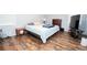 Bedroom with hardwood floors, bedside table and plenty of sunlight at 7505 Rico Rd, Chattahoochee Hills, GA 30268