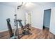 Bonus room featuring exercise equipment, hardwood floors, and freshly painted walls at 7505 Rico Rd, Chattahoochee Hills, GA 30268