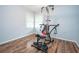 Bonus room featuring exercise equipment, hardwood floors, and freshly painted walls at 7505 Rico Rd, Chattahoochee Hills, GA 30268