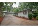 Charming single-story home with a brick facade, attached garage, and long driveway at 7505 Rico Rd, Chattahoochee Hills, GA 30268