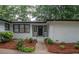 The home's front entrance is landscaped with lush greenery and leading to a welcoming front door at 7505 Rico Rd, Chattahoochee Hills, GA 30268