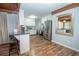 Bright kitchen featuring stainless steel appliances, breakfast bar and ample cabinet space at 7505 Rico Rd, Chattahoochee Hills, GA 30268
