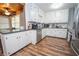 Kitchen features stainless steel appliances, white cabinets, and tile backsplash at 7505 Rico Rd, Chattahoochee Hills, GA 30268