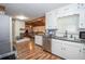 Open concept kitchen with stainless appliances and view to living room at 7505 Rico Rd, Chattahoochee Hills, GA 30268