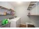 Laundry room with shelves, sink, and washer and dryer at 7505 Rico Rd, Chattahoochee Hills, GA 30268