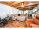 Inviting living room featuring wood beam ceiling, ceiling fan, hardwood floors and comfortable seating at 7505 Rico Rd, Chattahoochee Hills, GA 30268