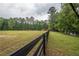 Expansive fenced yard with outbuildings, mature trees offering plenty of space and privacy at 7505 Rico Rd, Chattahoochee Hills, GA 30268