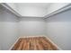 Empty walk-in closet with hardwood flooring, freshly painted walls, and shelf at 7505 Rico Rd, Chattahoochee Hills, GA 30268
