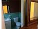 Cozy bathroom with a classic white toilet and sink, complemented by vintage blue tile halfway up the wall at 1681 Sw Hammond Woods Sw Cir, Marietta, GA 30008