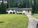 Split level home showcasing a well-maintained lawn and partial driveway at 1681 Sw Hammond Woods Sw Cir, Marietta, GA 30008