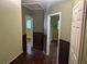 Hallway view with hardwood floors and paneled lower walls at 1681 Sw Hammond Woods Sw Cir, Marietta, GA 30008