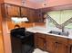 The kitchen is equipped with wooden cabinets and modern appliances at 1681 Sw Hammond Woods Sw Cir, Marietta, GA 30008