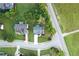 Aerial shot displays this property's prime corner lot location, enhanced by a lush lawn and mature trees at 327 Oakland Bay Ct, Loganville, GA 30052