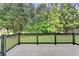 Back deck overlooking a beautifully landscaped yard with mature trees, offering privacy and a serene outdoor living space at 327 Oakland Bay Ct, Loganville, GA 30052