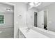 Bathroom features a white vanity with an expansive mirror and chrome hardware at 327 Oakland Bay Ct, Loganville, GA 30052