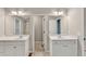 Bathroom featuring dual vanities and large mirrors at 327 Oakland Bay Ct, Loganville, GA 30052