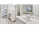 Bright bathroom featuring dual vanities, a soaking tub, and a separate shower at 327 Oakland Bay Ct, Loganville, GA 30052